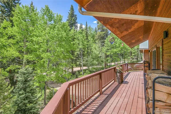 a view of balcony with wooden floor and fence