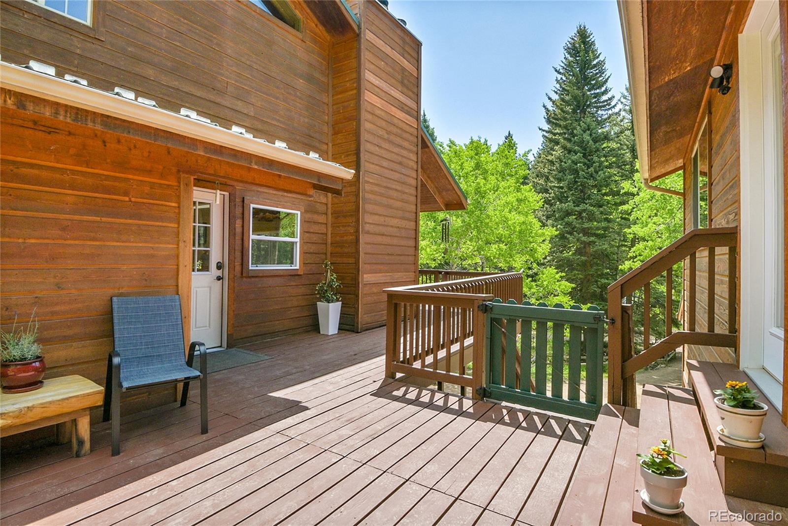 11182 Barney Gulch Road Conifer, CO 80433 - Photo 9 of 50 a view of balcony with wooden floor and outdoor seating