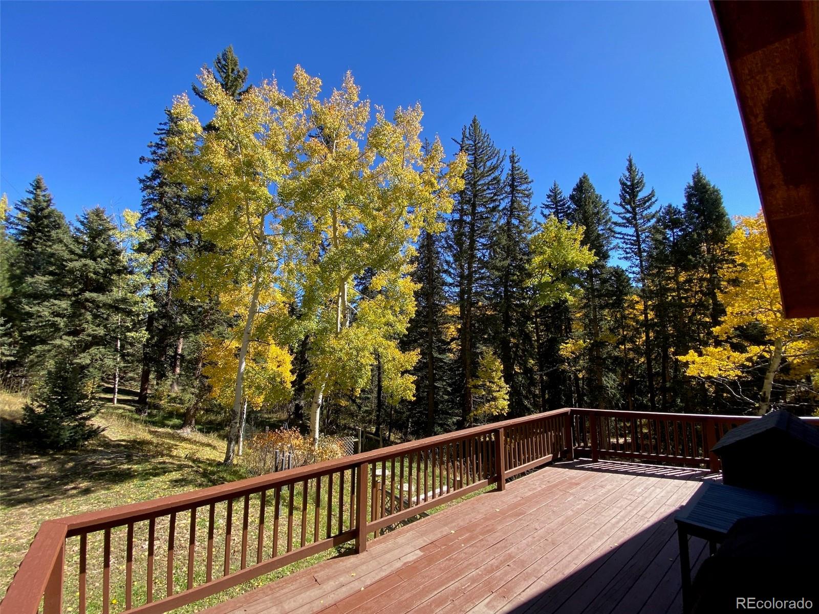 11182 Barney Gulch Road Conifer, CO 80433 - Photo 10 of 50 a view of a balcony with wooden floor and fence