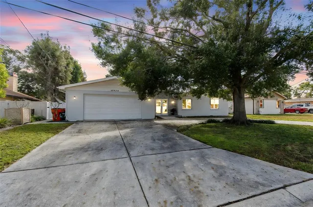 a front view of a house with a yard and a garage