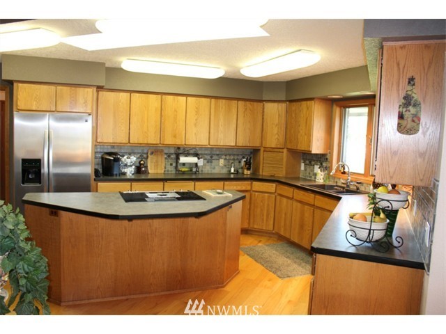 2127 Rice Road Chehalis, WA 98532 - Photo 7 of 25 a kitchen with stainless steel appliances granite countertop a sink a stove and a refrigerator