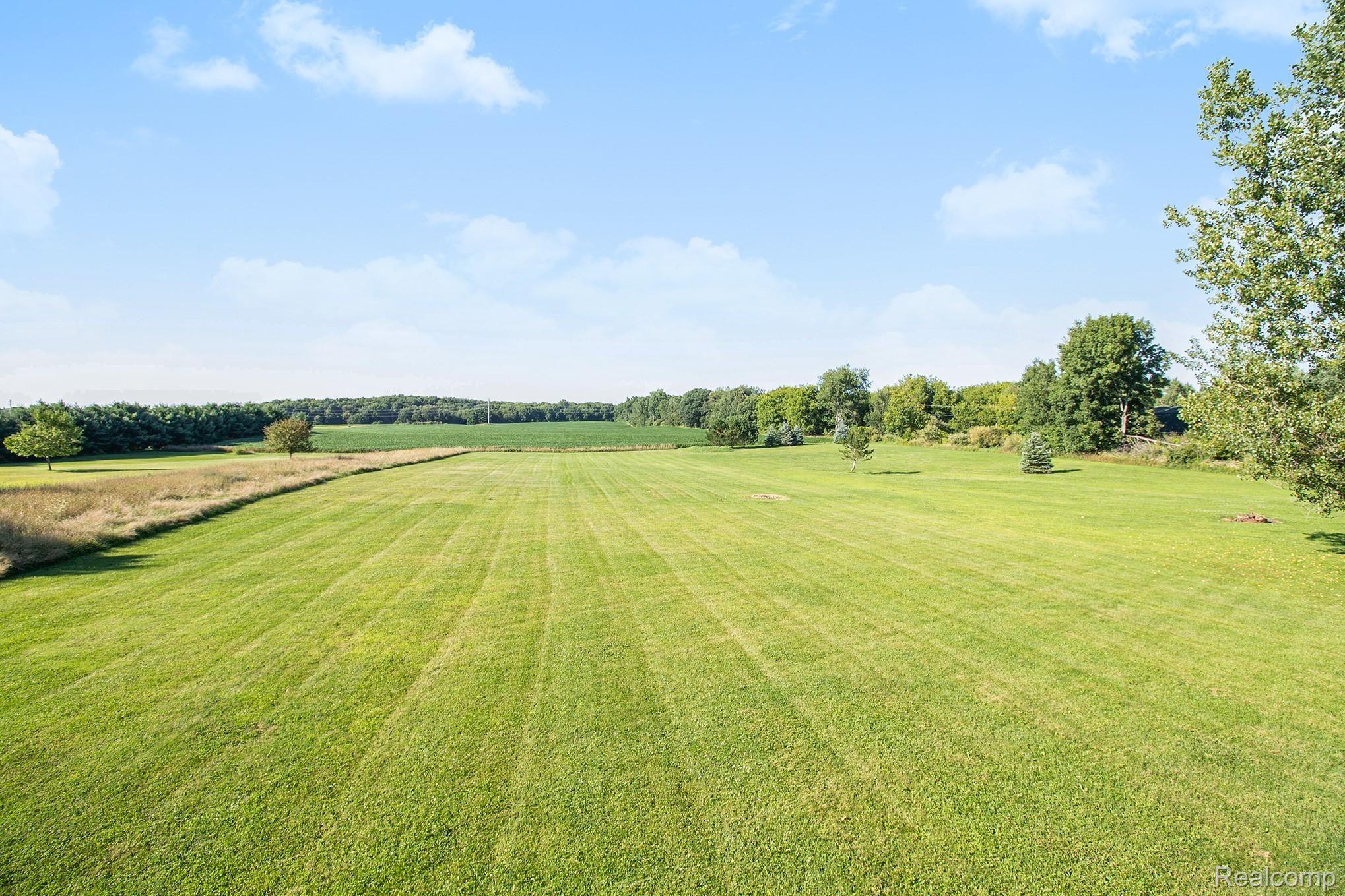 5040 West Coon Lake Road Howell, MI 48843 - Photo 21 of 27 Nice Open Yard, farmer planted fields in the rear