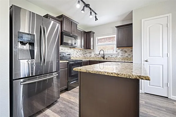 a kitchen with granite countertop cabinets a sink and dishwasher