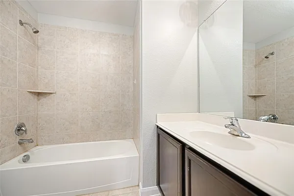 a bathroom with a sink a mirror and a bathtub