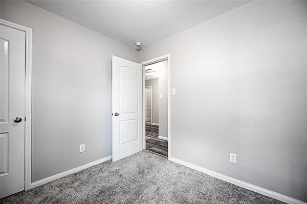 an empty room with closet and mirror