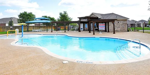 a view of a house with swimming pool and a yard
