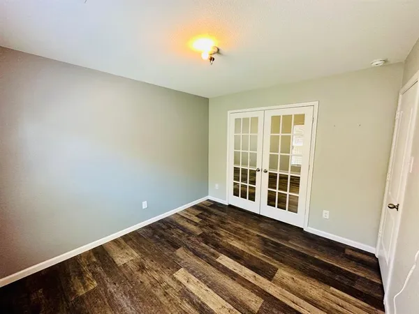 a view of a room with wooden floor