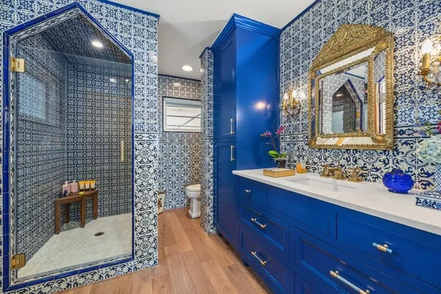 a bathroom with a sink mirror and tub