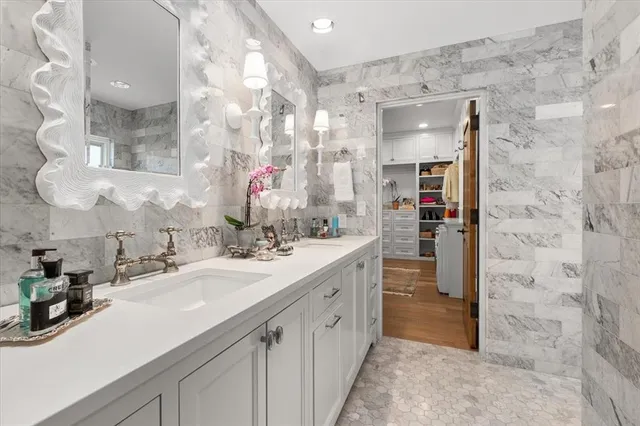 a spacious bathroom with a double vanity sink mirror and