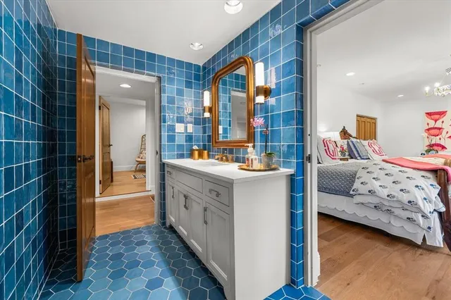 a en suite bathroom with a double vanity sink a mirror and a shower