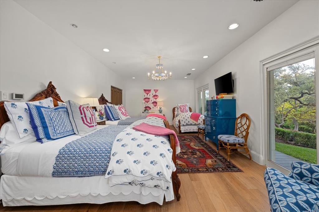 9308 Lechner Road Fort Worth, TX 76179 - Photo 22 of 40 a bedroom with furniture and a flat screen tv