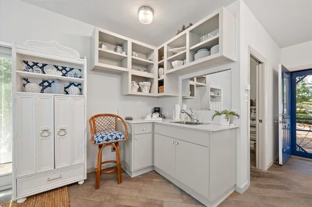 a view of cabinets with wooden floor and windows
