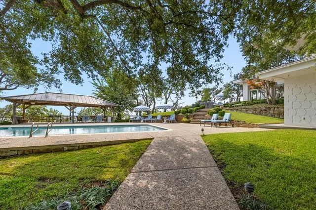 a view of a swimming pool with a patio