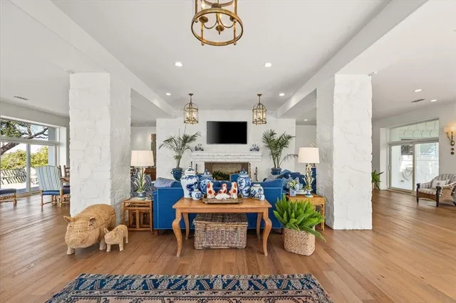 a living room with furniture a dining table and a fireplace