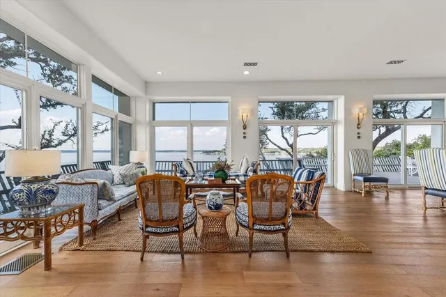 a dining room with furniture a chandelier and wooden floor