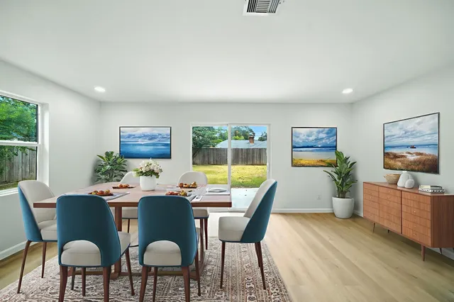 a dining room with furniture a window and wooden floor