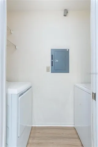 an empty room with windows and chandelier fan