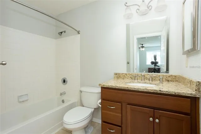 a view of swimming pool that has lawn chairs with plants and trees