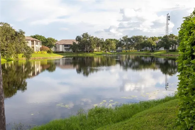 a view of front of house with sign board and yard