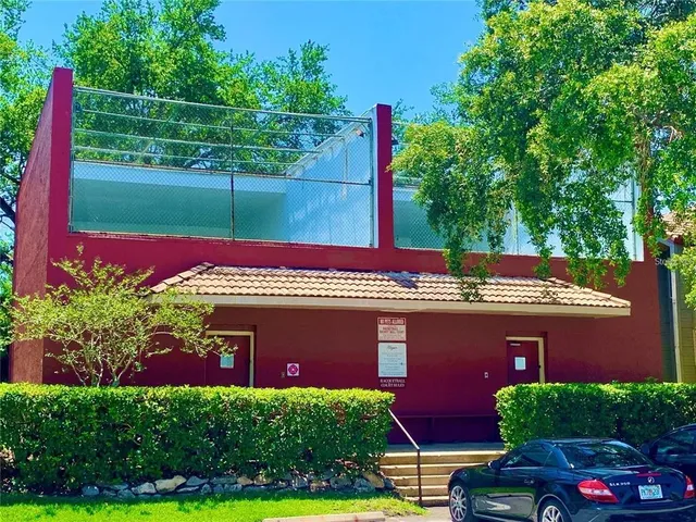a view of a backyard with swimming pool and plants