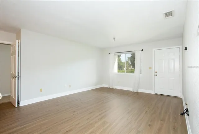 a view of a kitchen with wooden floor and a sink