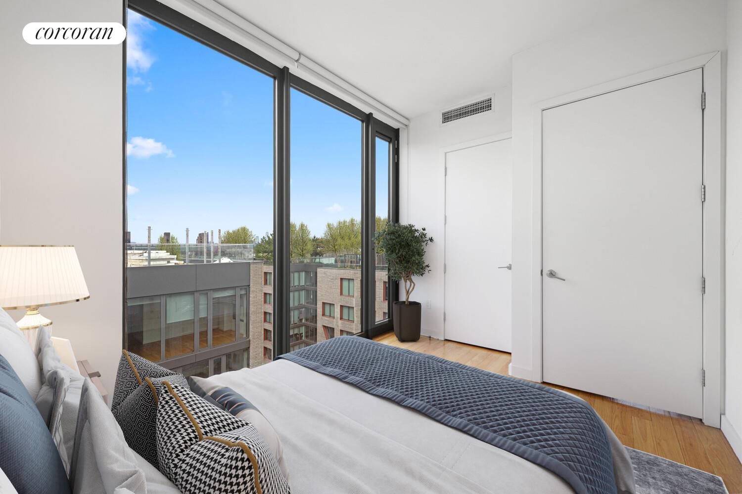 54 Noll Street, Unit 361 Brooklyn, NY 11206 - Photo 4 of 26 a bedroom with a bed and a night stand