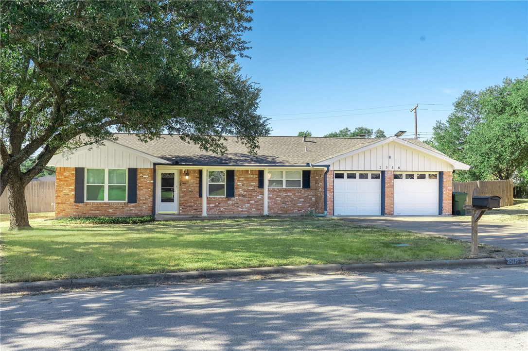 2316 Kent Street Bryan, TX 77802 - Photo 1 of 31 a front view of a house with a yard and garage
