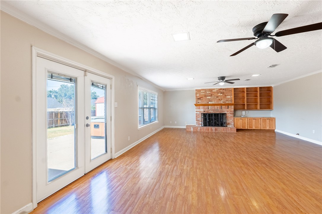 2316 Kent Street Bryan, TX 77802 - Photo 12 of 31 an empty room with wooden floor fan and windows