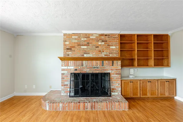 a living room with a fireplace and a wooden floor