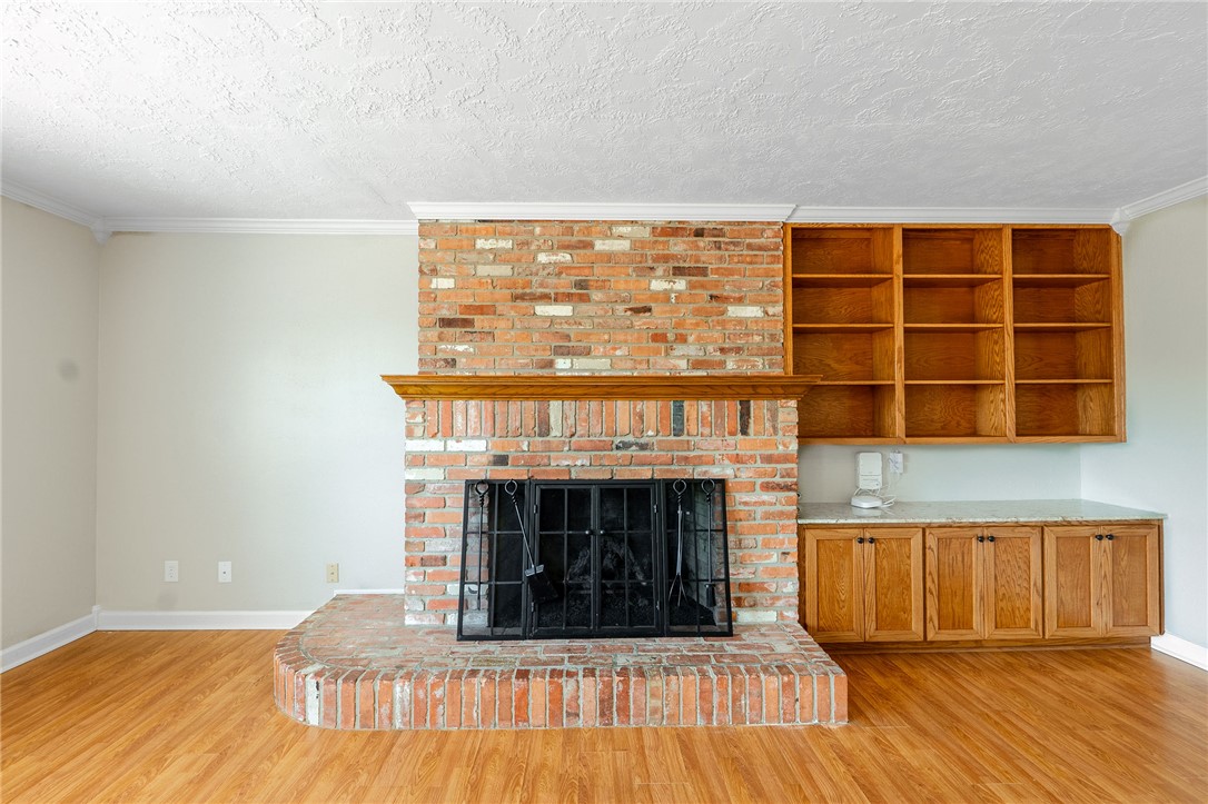 2316 Kent Street Bryan, TX 77802 - Photo 13 of 31 a living room with a fireplace and a wooden floor