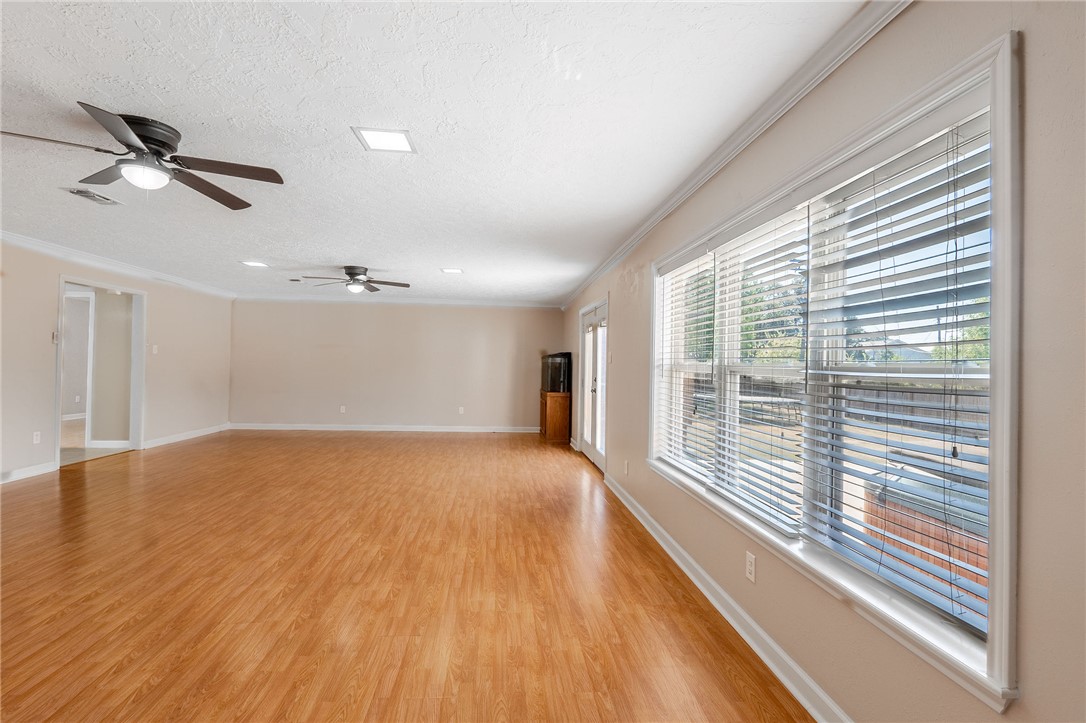 2316 Kent Street Bryan, TX 77802 - Photo 14 of 31 a view of an empty room with a window and wooden floor
