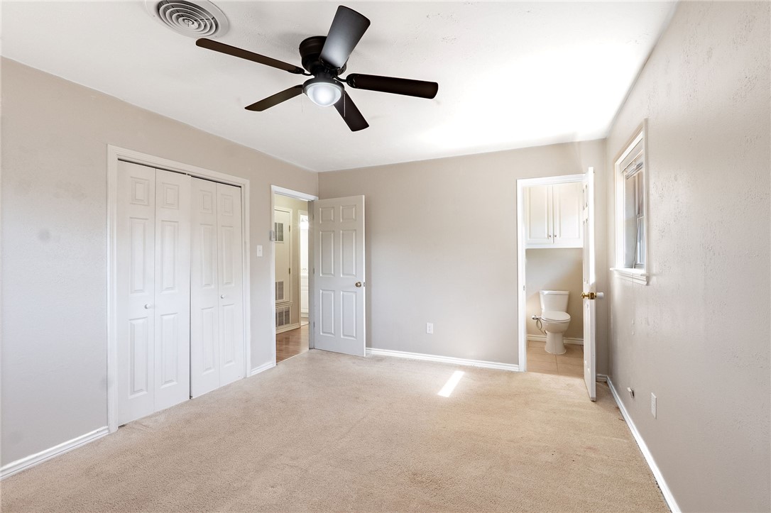 2316 Kent Street Bryan, TX 77802 - Photo 16 of 31 a view of a livingroom with a ceiling fan & windows
