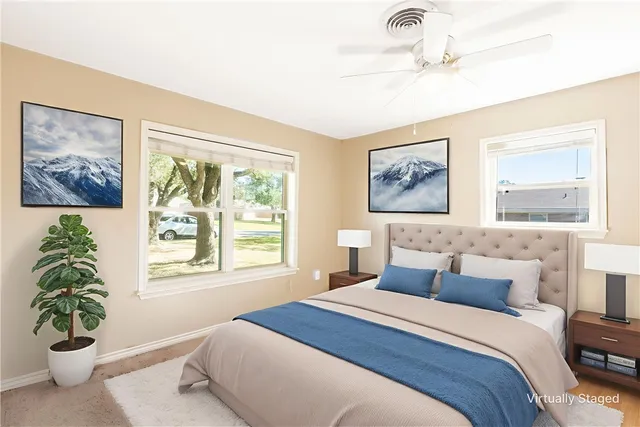 a bedroom with a large bed and a window