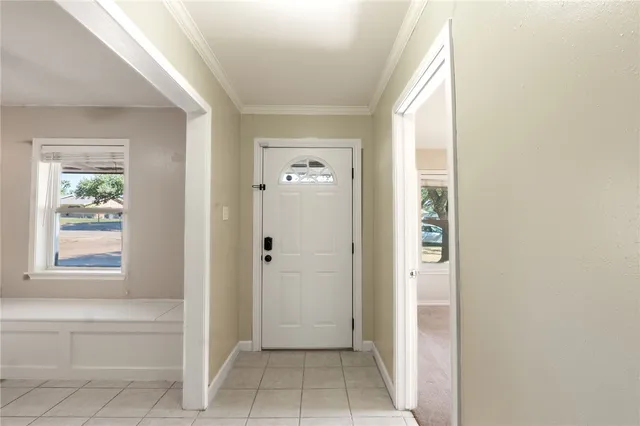 a view of a hallway with windows and entryway