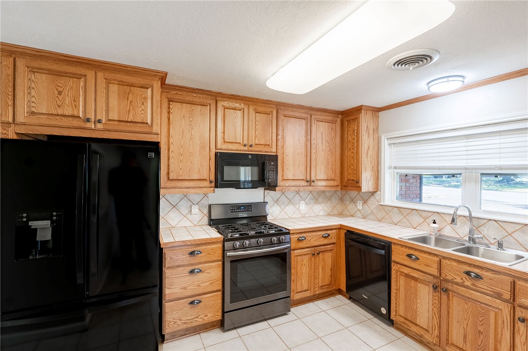 2316 Kent Street Bryan, TX 77802 - Photo 6 of 31 a kitchen with granite countertop cabinets stainless steel appliances and a window