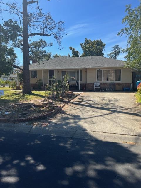 22030 Hibiscus Drive Cupertino, CA 95014 - Photo 1 of 5 a front view of a house with a yard
