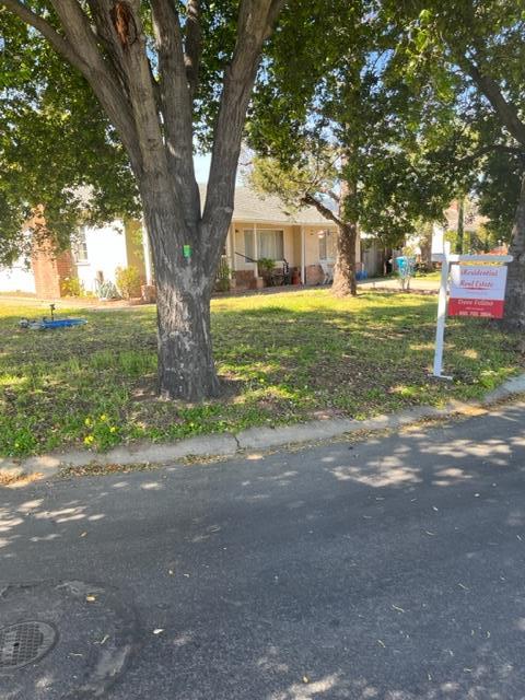 22030 Hibiscus Drive Cupertino, CA 95014 - Photo 3 of 5 a front view of a house with a yard and garage