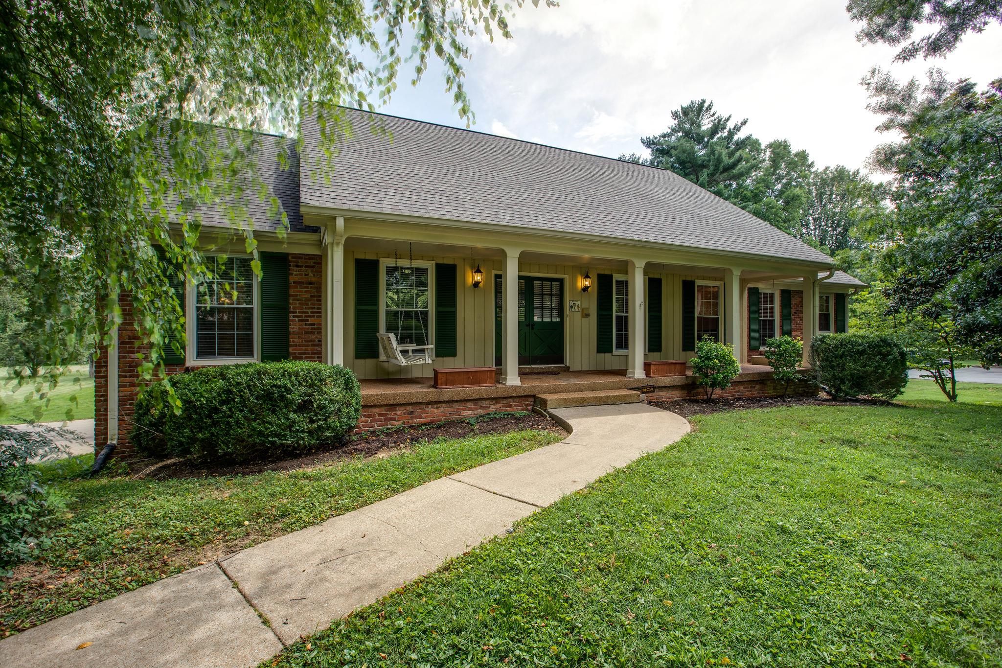 6737 Holt Road Nashville, TN 37211 - Photo 2 of 28 This home has a welcoming front porch,and is shaded by towering trees