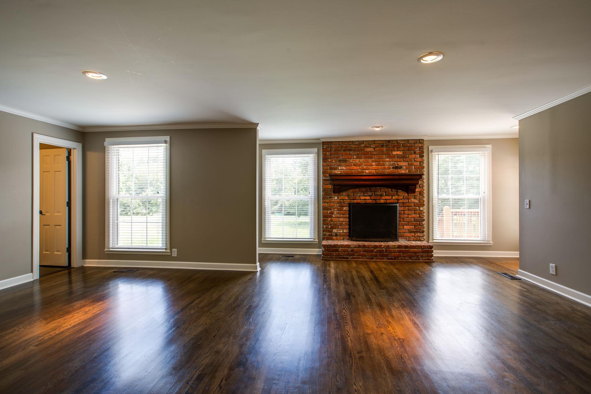 6737 Holt Road Nashville, TN 37211 - Photo 6 of 28 Gleaming hardwood floors,a brick fireplace and views of the backyard from the large Den