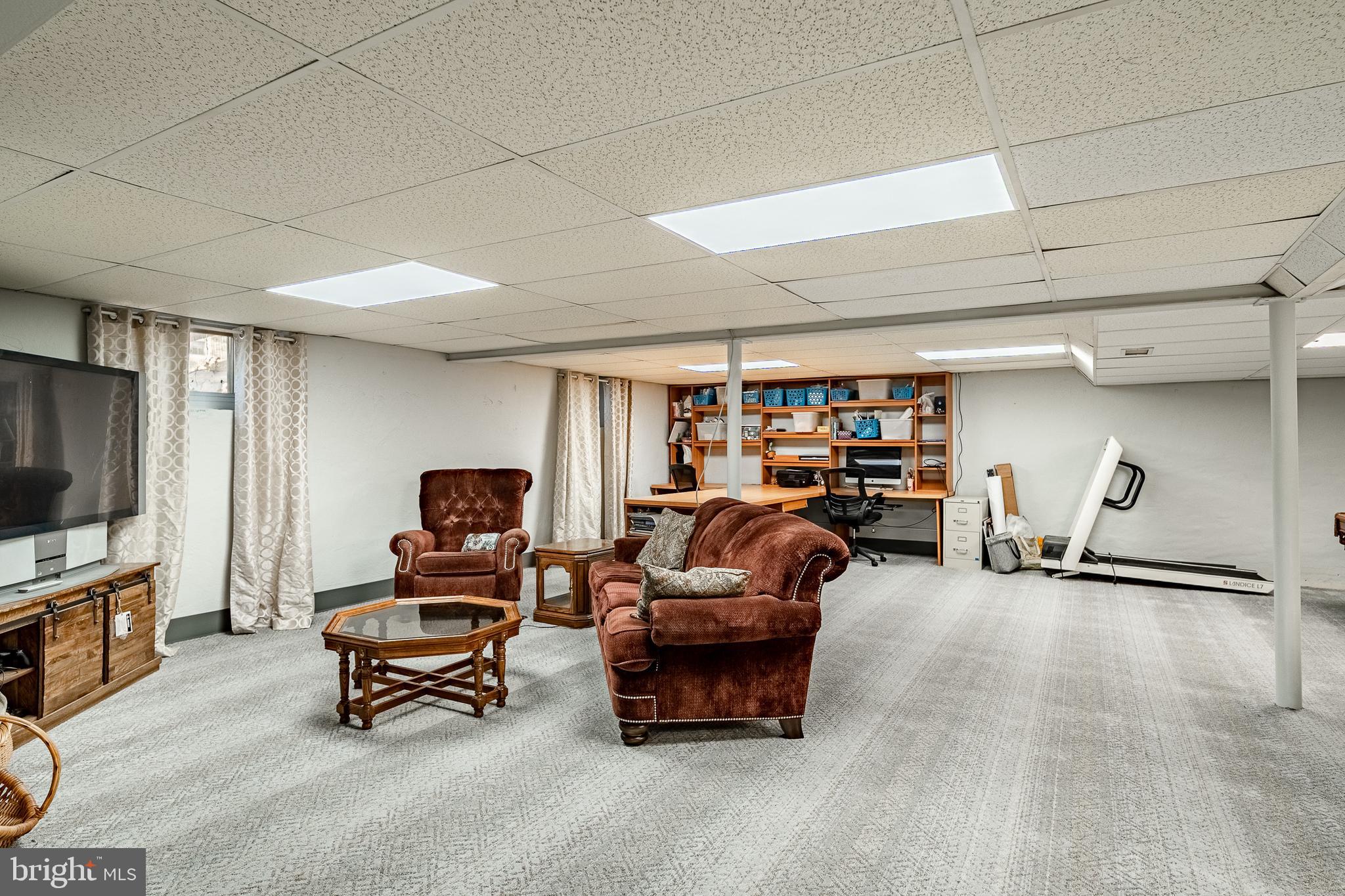 3920 Darby Road Bryn Mawr, PA 19010 - Photo 30 of 54 a living room with furniture gym equipment and a flat screen tv
