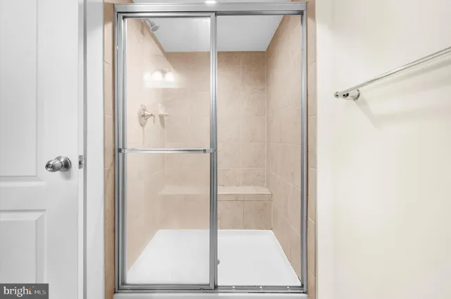 a bathroom with a glass shower door