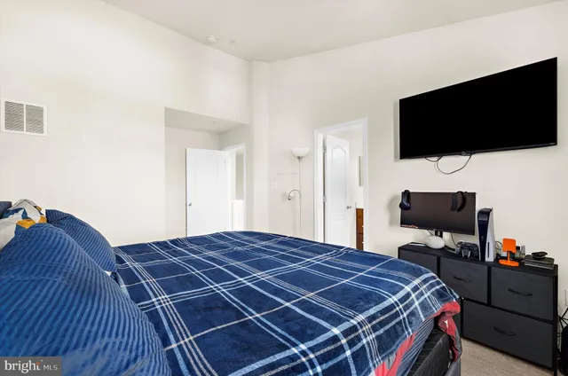 a bedroom with a bed and a flat screen tv