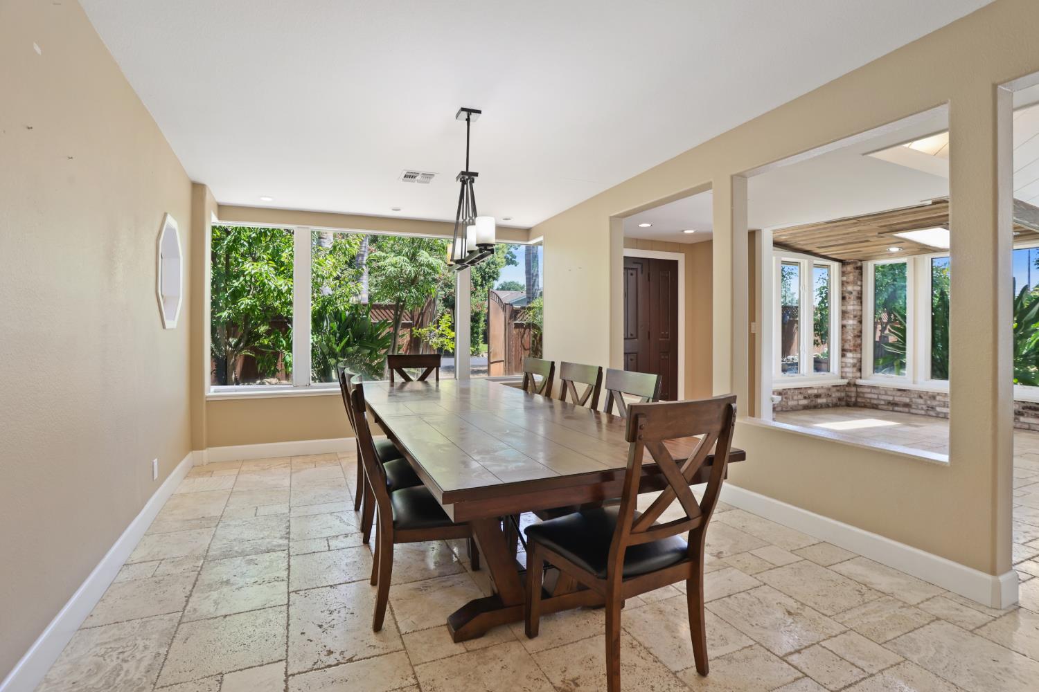 9935 Hazel Road Stockton, CA 95212 - Photo 19 of 98 a dining room with furniture a chandelier and a rug