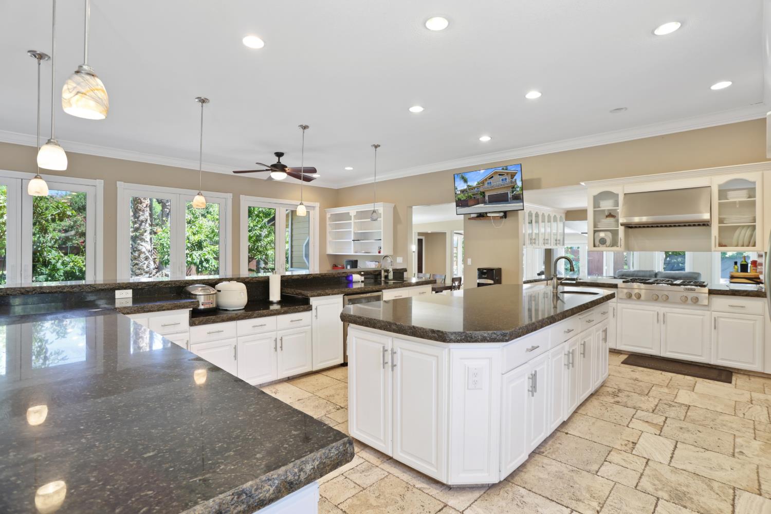 9935 Hazel Road Stockton, CA 95212 - Photo 28 of 98 a large kitchen with kitchen island lots of counter space a sink a window and living room view