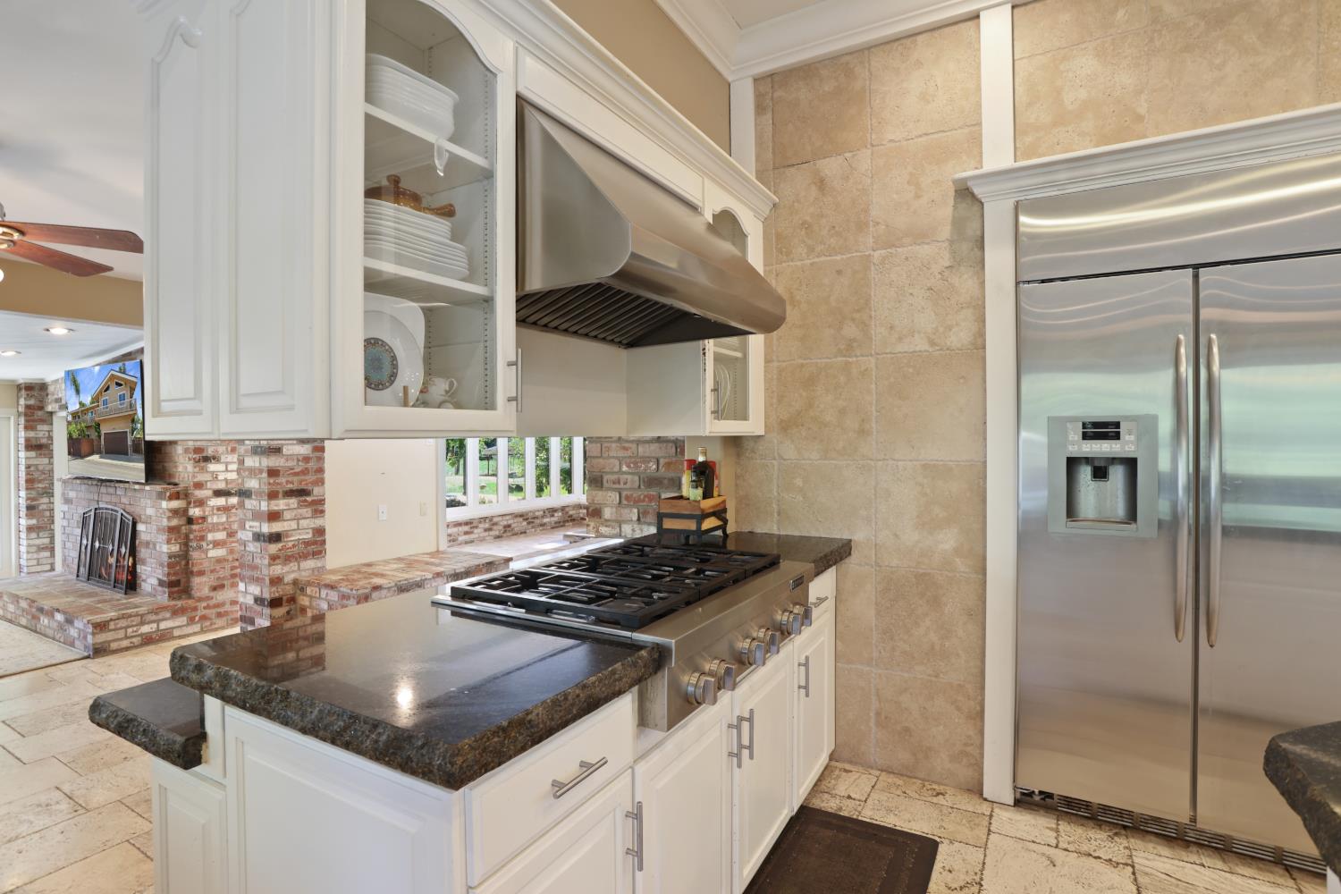 9935 Hazel Road Stockton, CA 95212 - Photo 32 of 98 a kitchen with stainless steel appliances granite countertop a sink stove and refrigerator