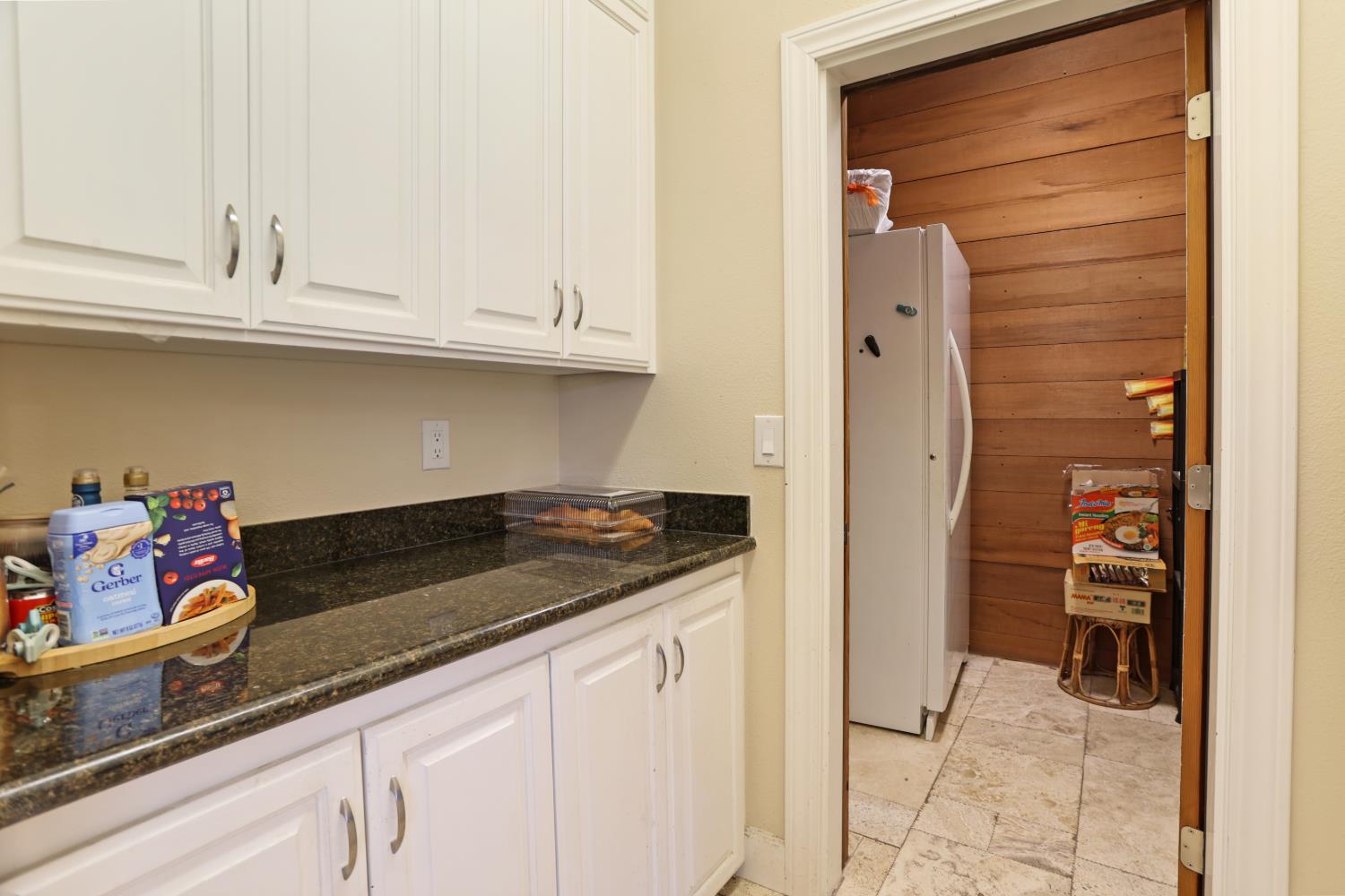 9935 Hazel Road Stockton, CA 95212 - Photo 35 of 98 a kitchen with granite countertop a sink and cabinets
