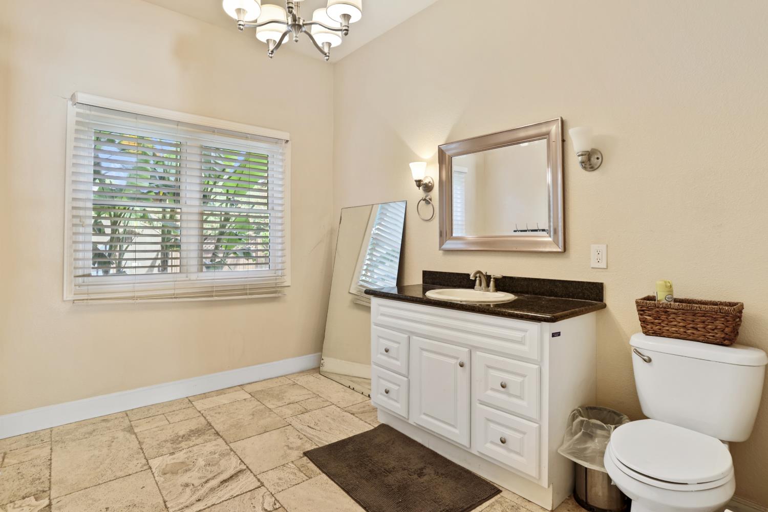 9935 Hazel Road Stockton, CA 95212 - Photo 37 of 98 a bathroom with a toilet a sink a mirror a window and vanity