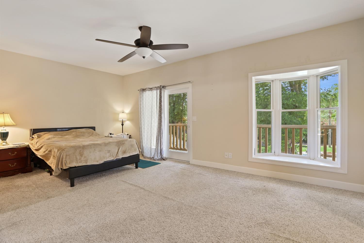 9935 Hazel Road Stockton, CA 95212 - Photo 44 of 98 a spacious bedroom with a bed and a window
