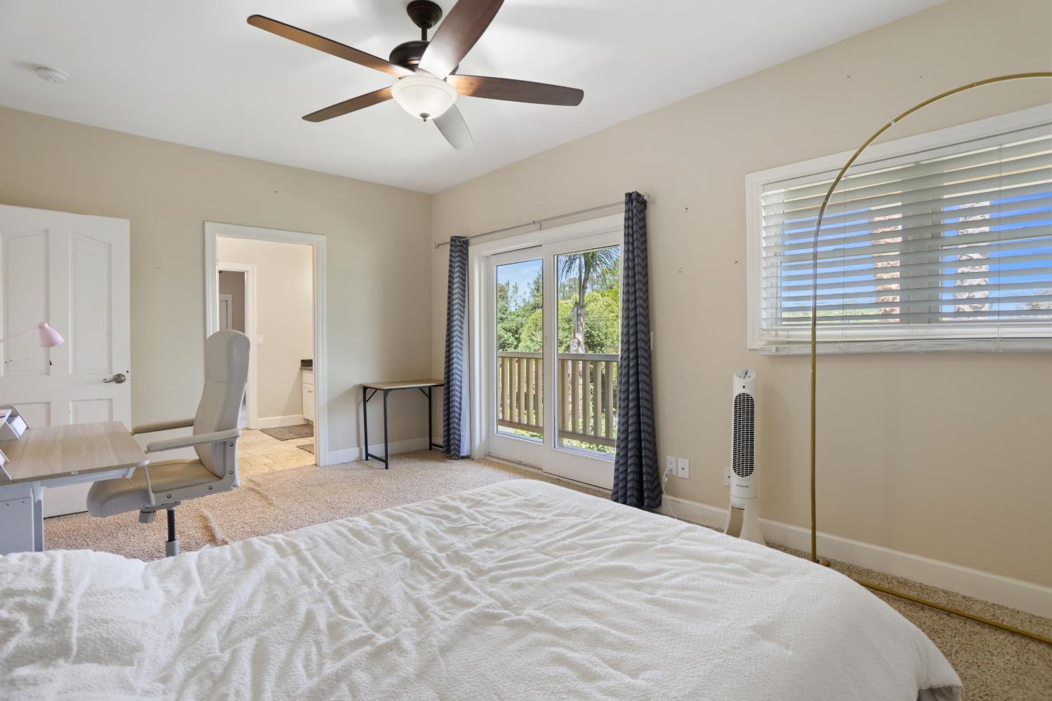 9935 Hazel Road Stockton, CA 95212 - Photo 48 of 98 a bedroom with a bed and a chandelier