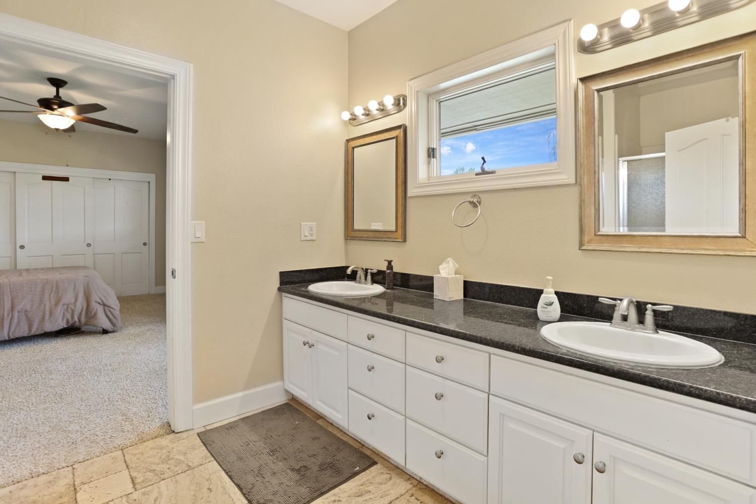 9935 Hazel Road Stockton, CA 95212 - Photo 49 of 98 a en suite bathroom with double sink and a mirror